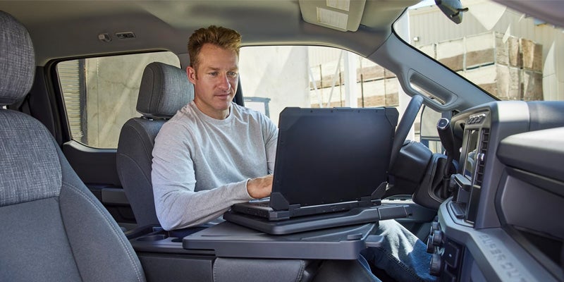 2024 Ford Super Duty man on computer in drivers seat