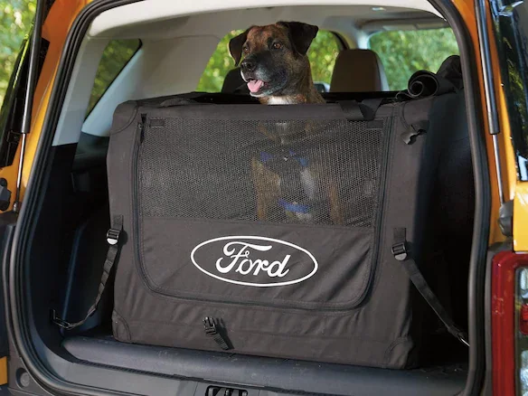 A dog in a Ford dog kennel.